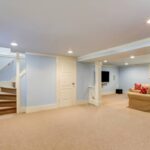 residential basement with tan carpet flooring and light blue walls near Breese, IL