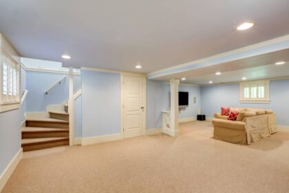 residential basement with tan carpet flooring and light blue walls near Breese, IL