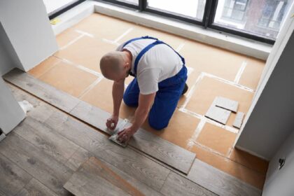 Person installing laminate flooring panels at Preferred Flooring near Breese, IL