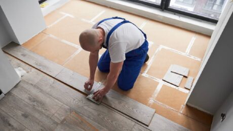 Person installing laminate flooring panels near Breese, IL