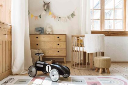 Light hardwood floors in a nursery with a hopscotch area rug and racecar riding toy near Breese, IL