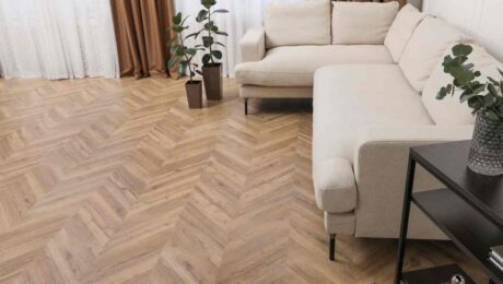 Trendy, light-colored hardwood flooring with a herringbone pattern in a chic yet cozy living room at Preferred Flooring near Breese, IL